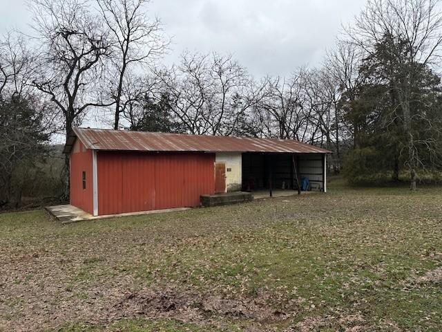 view of outbuilding featuring a lawn