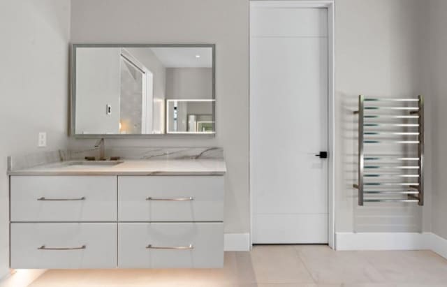 bathroom featuring vanity, radiator heating unit, and tile patterned floors