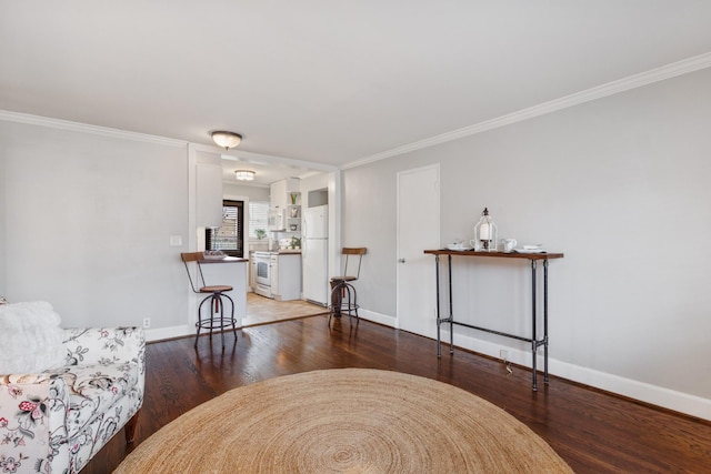 living area with crown molding and dark hardwood / wood-style floors