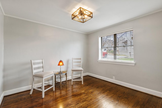 sitting room with ornamental molding and dark hardwood / wood-style floors