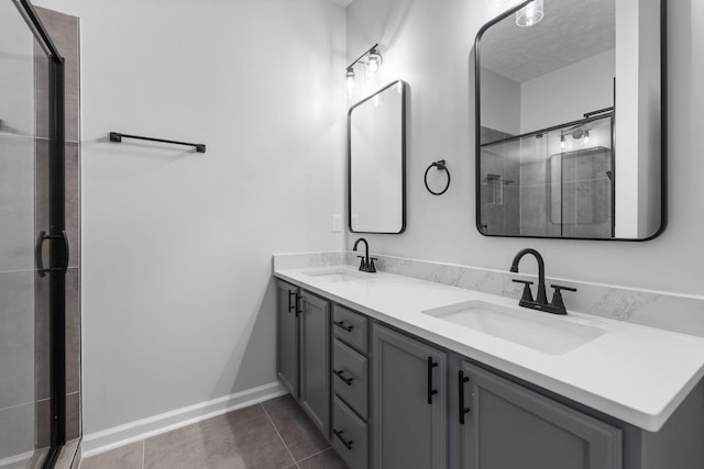 bathroom featuring an enclosed shower, vanity, tile patterned floors, and a textured ceiling