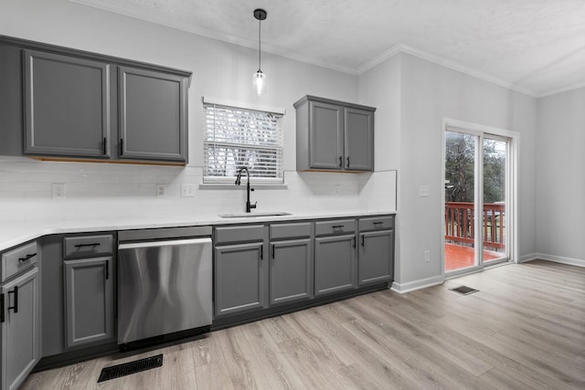 kitchen with sink, decorative light fixtures, gray cabinets, dishwasher, and light hardwood / wood-style floors