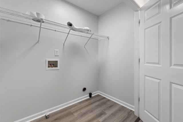 laundry area featuring hookup for a gas dryer, hookup for a washing machine, and hardwood / wood-style floors