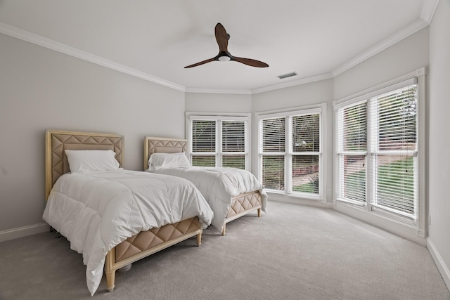 bedroom with light colored carpet, ornamental molding, and ceiling fan