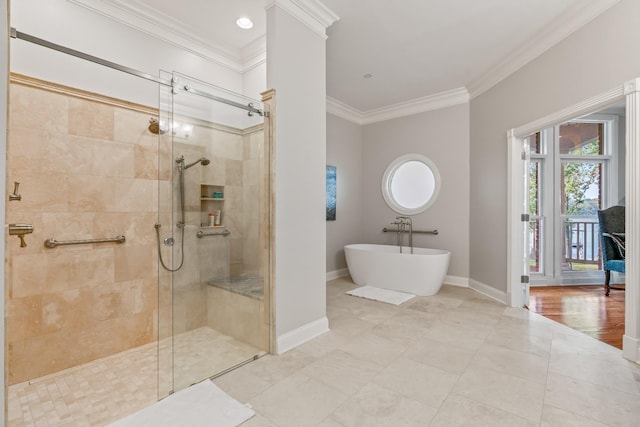 bathroom with ornamental molding and separate shower and tub