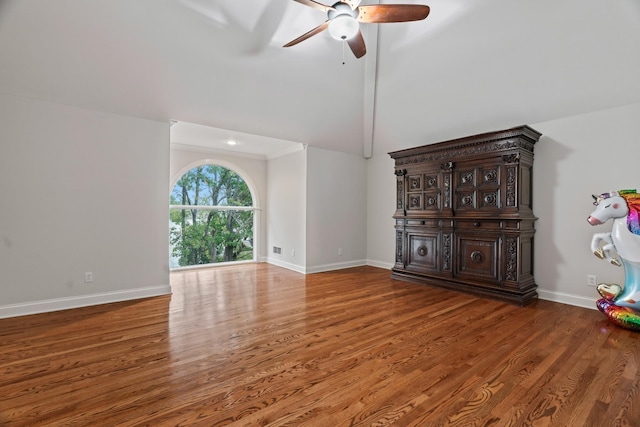 unfurnished living room with wood-type flooring, ceiling fan, and high vaulted ceiling