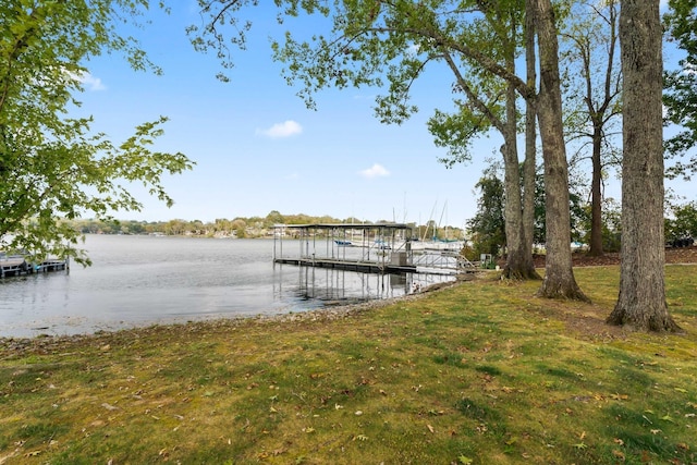 dock area featuring a yard and a water view