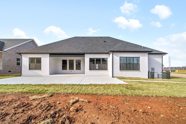 rear view of house with a lawn, cooling unit, and a patio area