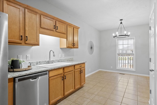 kitchen with sink, light stone counters, decorative light fixtures, a chandelier, and stainless steel appliances