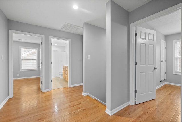 hall featuring light hardwood / wood-style flooring and plenty of natural light