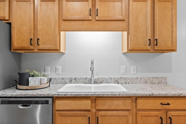 kitchen with dishwasher, light stone countertops, and sink