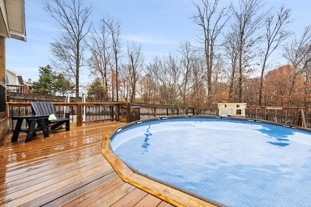 view of swimming pool with a wooden deck