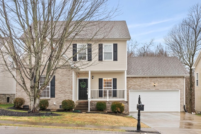 colonial home with a porch and a garage