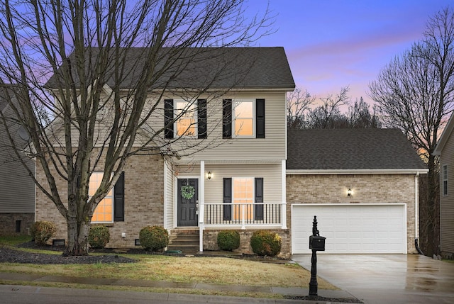 view of front facade with a garage and covered porch