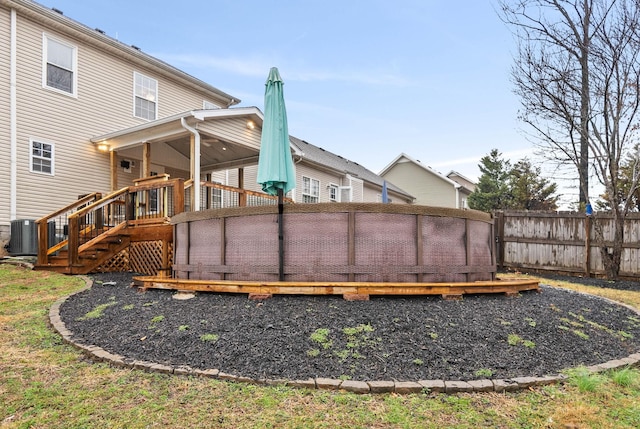 exterior space featuring a wooden deck and central air condition unit