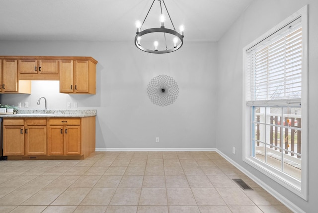 kitchen featuring an inviting chandelier, light tile patterned flooring, sink, and hanging light fixtures