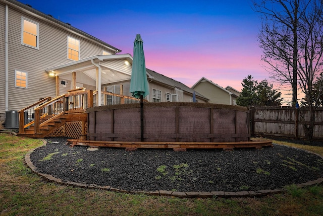 exterior space with central AC unit, a sunroom, and a deck