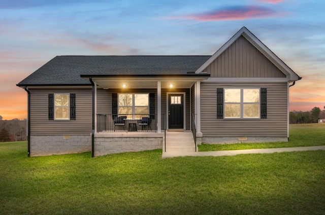 view of front of home with a lawn and covered porch