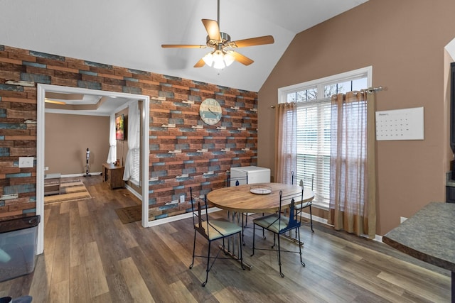 dining area with lofted ceiling, dark hardwood / wood-style floors, and ceiling fan