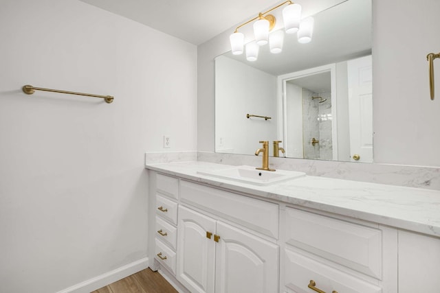 bathroom with vanity, hardwood / wood-style floors, and walk in shower