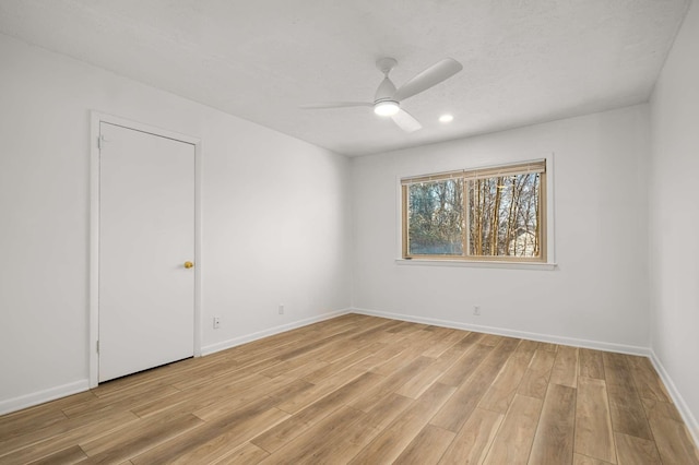 spare room featuring a textured ceiling, ceiling fan, and light hardwood / wood-style flooring