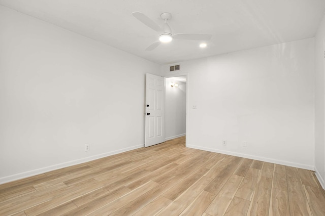 empty room with ceiling fan and light hardwood / wood-style floors