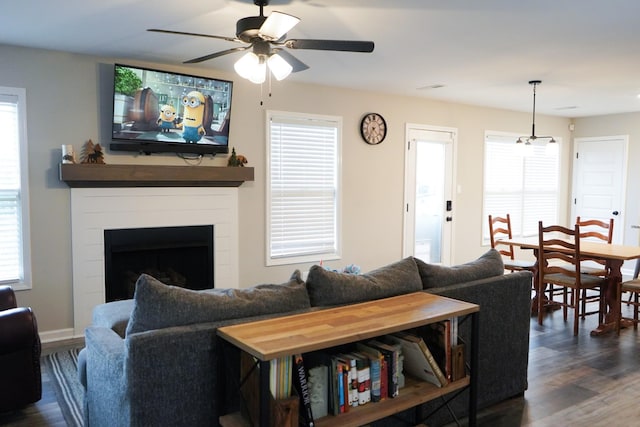 living room featuring ceiling fan and dark hardwood / wood-style flooring