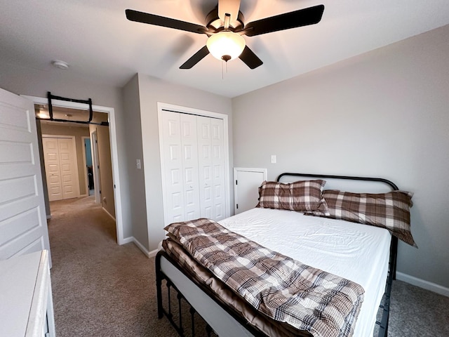 carpeted bedroom featuring ceiling fan and a closet