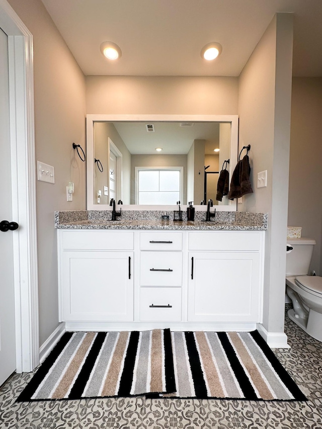 bathroom with vanity and toilet