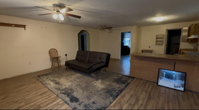 living room featuring hardwood / wood-style flooring and ceiling fan