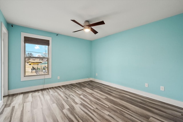 spare room with light hardwood / wood-style flooring and ceiling fan