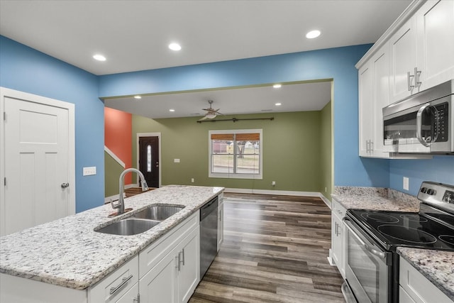 kitchen with sink, stainless steel appliances, dark hardwood / wood-style floors, an island with sink, and white cabinets