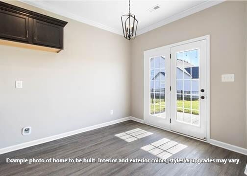 interior space with crown molding, a chandelier, and dark wood-type flooring