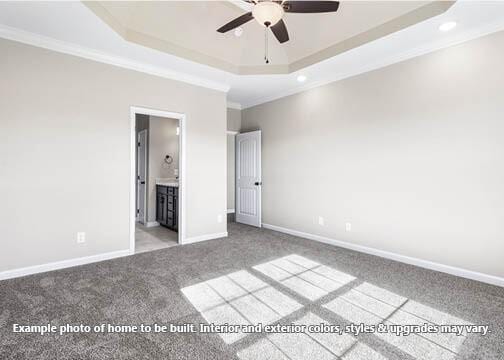 unfurnished bedroom featuring a raised ceiling, crown molding, connected bathroom, and light colored carpet