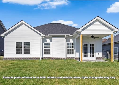 rear view of house featuring french doors, ceiling fan, and a lawn