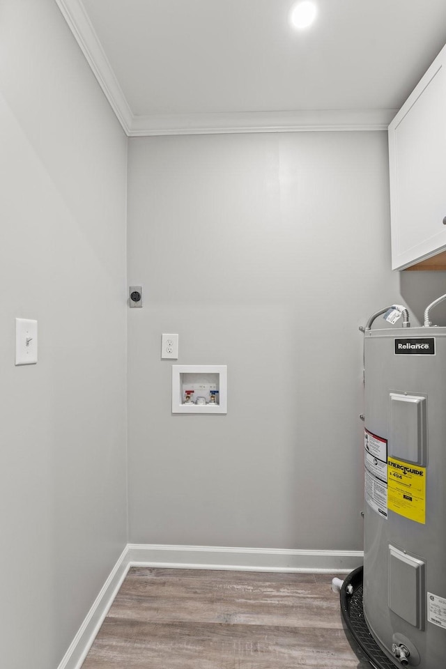 clothes washing area featuring baseboards, cabinet space, electric water heater, and hookup for an electric dryer