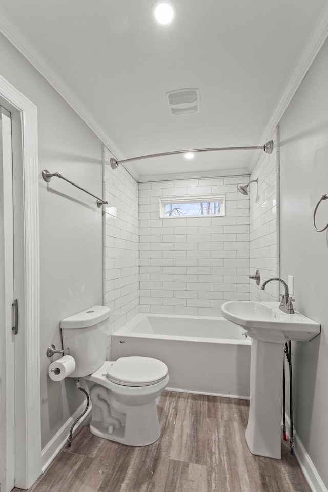 bathroom featuring  shower combination, ornamental molding, toilet, and wood finished floors