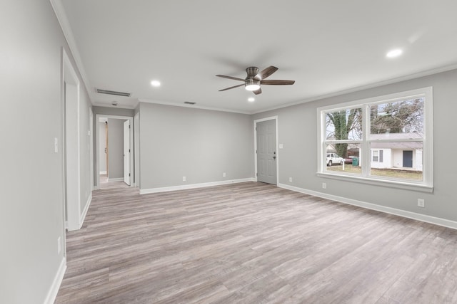 empty room featuring baseboards, visible vents, and light wood-style floors