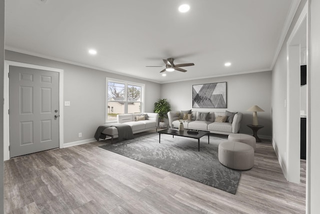 living area featuring ornamental molding, light wood finished floors, and baseboards