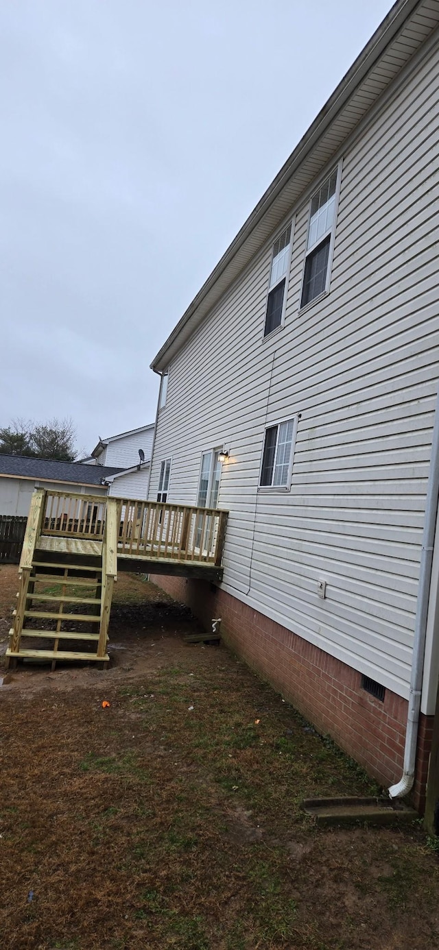 view of side of property with a wooden deck