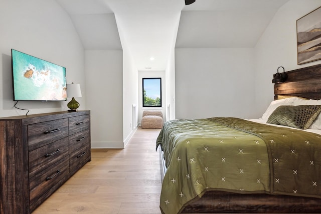 bedroom with vaulted ceiling and light hardwood / wood-style floors