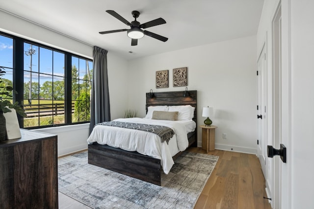 bedroom with ceiling fan and light hardwood / wood-style flooring