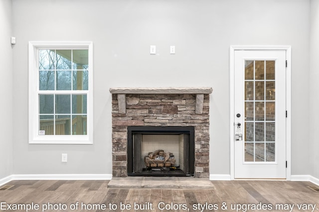 room details with a stone fireplace and hardwood / wood-style floors