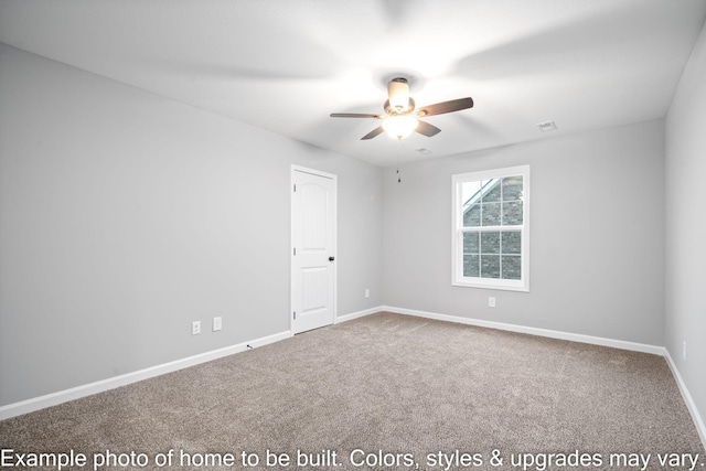 carpeted spare room with ceiling fan