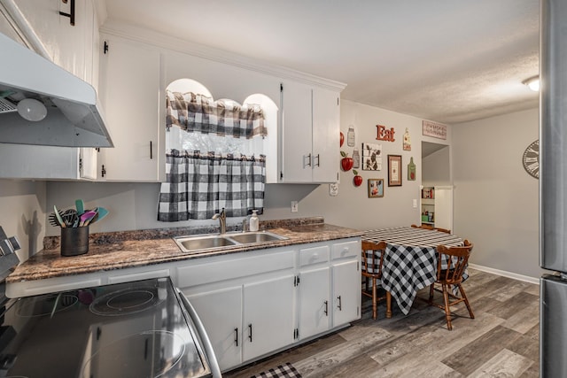 kitchen featuring light hardwood / wood-style floors, sink, stainless steel range with electric cooktop, and white cabinets