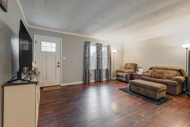 entryway with crown molding, dark hardwood / wood-style flooring, and a textured ceiling