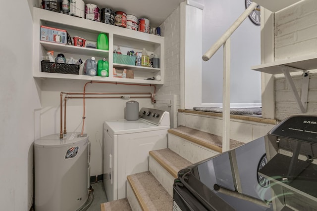 clothes washing area featuring electric water heater and washing machine and clothes dryer