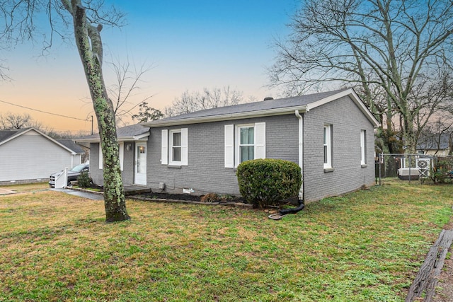 ranch-style home featuring a lawn