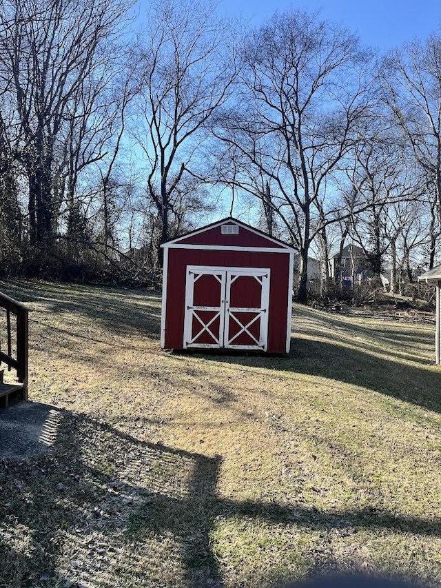 view of outbuilding with a yard