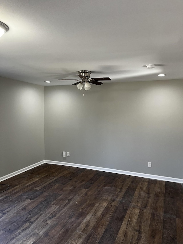 empty room with dark wood-type flooring and ceiling fan